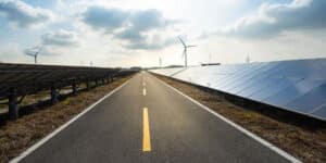 Road with solar and wind in the background